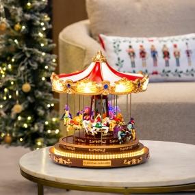 VILLA NAVIDEÑA CARRUSEL DE PLÁSTICO CON LUCES, MÚSICA Y MOVIMIENTO 40 CM