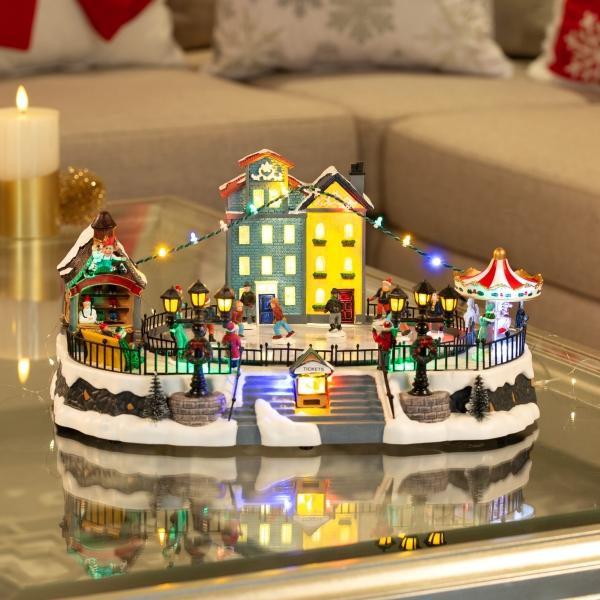 VILLA NAVIDEÑA CON PATINADERO DE PLÁSTICO ILUMINADA CON MOVIMIENTO 41 CM
